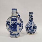 Two Chinese porcelain blue and white Qing Dynasty vases, the first of moonflask form with pierced