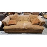 A Tetrad large three seat sofa upholstered in a coffee coloured fabric with floral decoration,