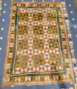 Early 20th century Pakistani quilt, perhaps Ralli, with chequered design in pink, green, ochre,