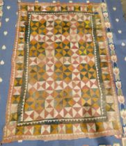 Early 20th century Pakistani quilt, perhaps Ralli, with chequered design in pink, green, ochre,