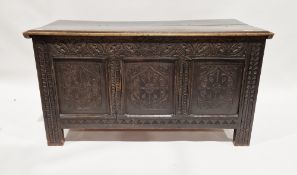 Antique oak coffer, the planked top with lunette frieze, the three-framed panel front scroll