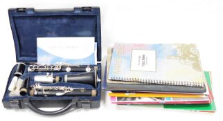 Buffet, Crampon & Sons Paris ebony clarinet in hard case, model B12 and a collection of sheet music