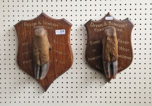 Two taxidermy deer stag hooves, each on inscribed oak wall mounts, the first named for Devon and