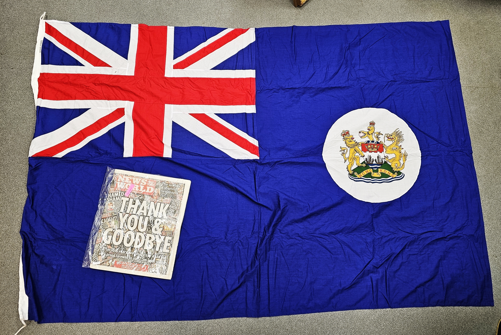 Hong Kong colony flag and a copy of News of the World 10th July 2011 documenting the handover of