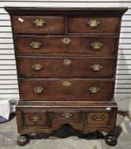 Georgian oak chest on stand, the moulded top above two short drawers and three long graduating