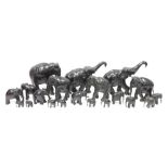 Collection of ebony and bone-mounted models of elephants in sizes, each naturalistically carved