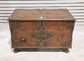 Stained hardwood Indonesian coffer, adorned with embossed brass plaques and rivets, the centre