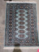 Small contemporary Eastern wool rug with seven quartered guls to the turquoise ground, 90cm x 63cm