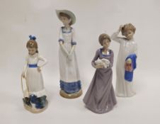 Four Nao figures of children, printed brown marks, various impressed letters and numerals,