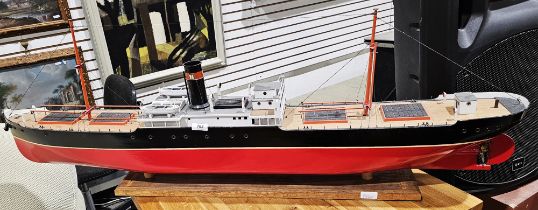 Early to mid 20th century model of a tramp ship steamer, named 'Darwin', with red painted hull, on