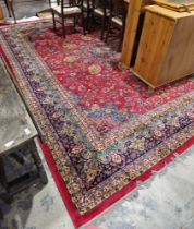 Large carpet of Persian design, having central floral arabesque and surround of scrolling foliage