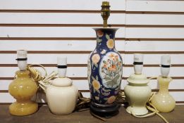 Oriental-style table lamp, blue ground with floral and bird design fixed to wooden base, two table