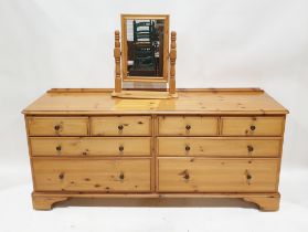 Modern pine low dresser by Ducal, comprising four short and four long drawers, each with metal