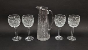 Four cut glass red wine glasses by Fred Curtis, each cut with a band of ovolos above hobnail