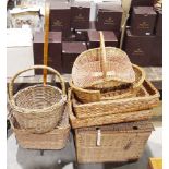 Selection of wicker baskets to include a picnic hamper, a shopping basket trolley, bread baskets,