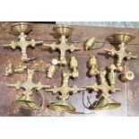 Assorted brass wall lights, each in the Victorian-style cast with scrolling branch and flowerheads