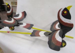 Two vintage children's painted wooden push-a-long bird toys, painted in black with red and white