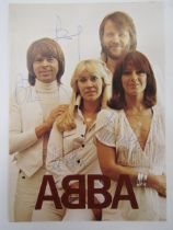 Signed ABBA publicity card featuring a photograph of all four members of the band, signed by each,