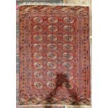 Eastern red ground rug with three rows of eight quartered elephant foot guls, on geometric field