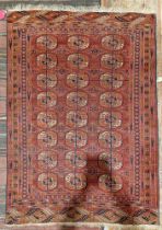 Eastern red ground rug with three rows of eight quartered elephant foot guls, on geometric field