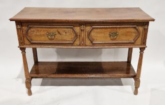 Oak two-tier sideboard having two short deep drawers, over a single storage shelf, on turned legs,