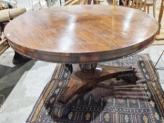 Large early Victorian rosewood tilt-top dining table of circular form, with carved floral central