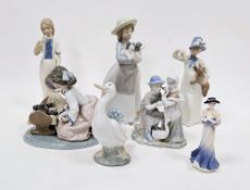 Group of Lladro, Nao, Rex and other porcelain figures similar, including a Lladro group of a girl