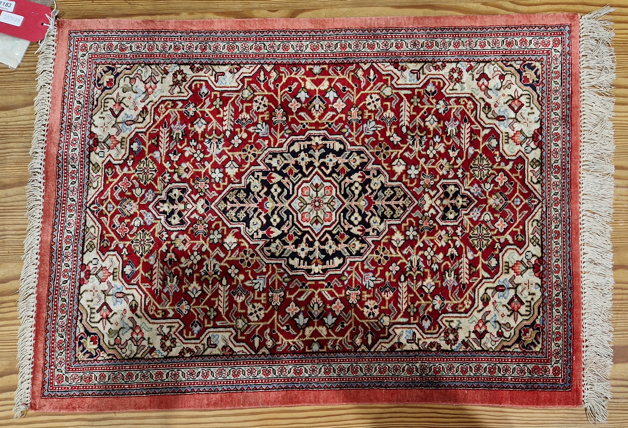 Persian silk rug, red ground with central floral lozenge on floral field, floral  cream spandrals to