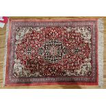 Persian silk rug, red ground with central floral lozenge on floral field, floral  cream spandrals to