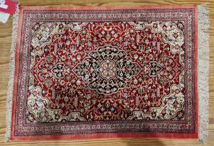 Persian silk rug, red ground with central floral lozenge on floral field, floral  cream spandrals to