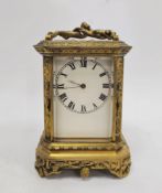 French late 19th century gilt-brass mounted carriage clock, with figural swing handle above bevelled
