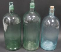 Three large green-blue glass bottles and stoppers, one named for POISON, one cork stopper a