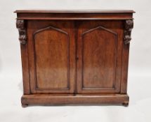 Victorian mahogany sideboard with arched panel doors revealing shelves, with carved decoration, on