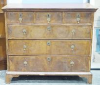 Early 18th century walnut chest of three short drawers and four long drawers, inlaid border, brass