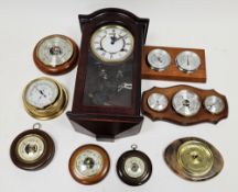 Collection of circular barometers, one mounted with a thermometer, another with thermometer and