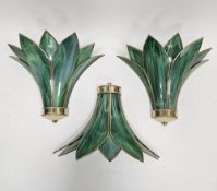 Set of three modern green glass and brass mounted wall lights of stylised Art Deco leaf design (