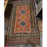 19th century red ground kilim with three central lozenges, eight elephant's foot guls and multiple