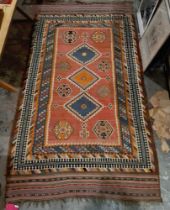 19th century red ground kilim with three central lozenges, eight elephant's foot guls and multiple