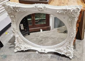 Large white painted rectangular wall mirror with high relief moulded floral decorated frame,