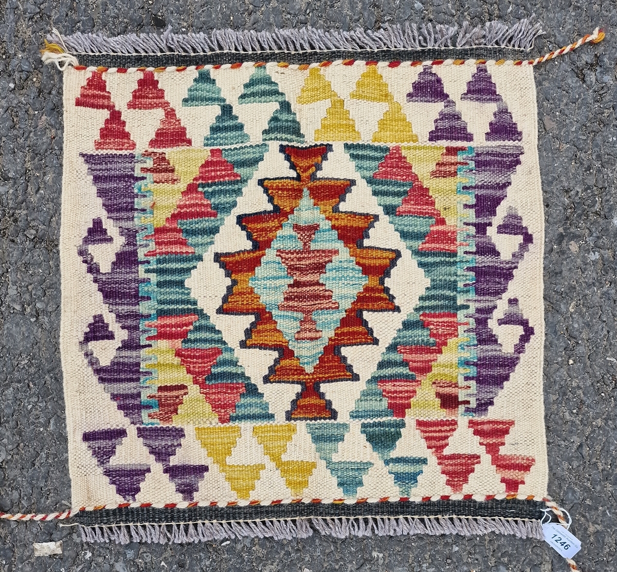 Chobi kilim, woven with a geometric medallion in red, blue and ochre reserved on a cream ground - Image 2 of 2