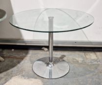 Modern glass-topped dining table of circular form, on a chromed metal base, 74cm high x 100cm