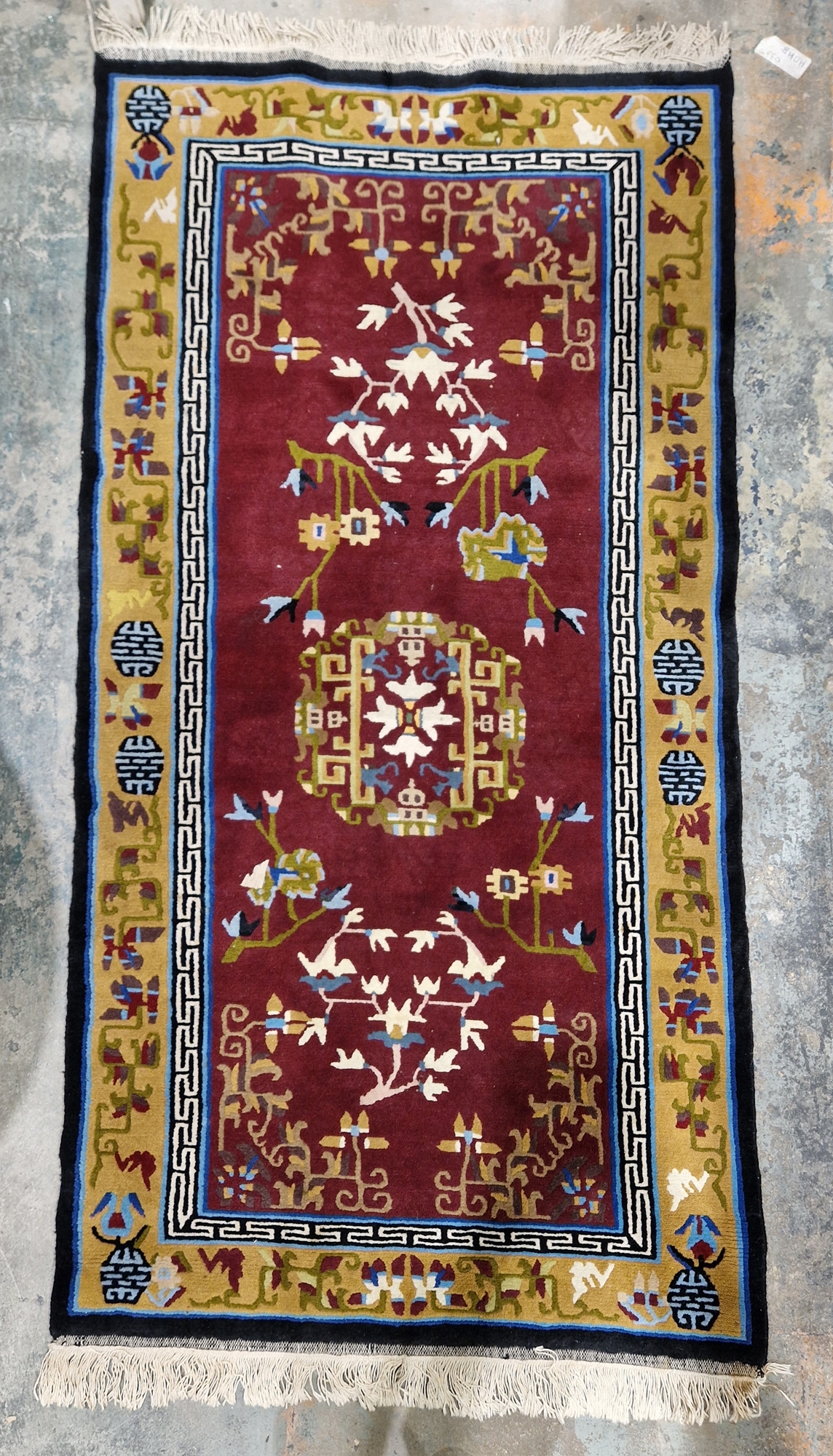 Chinese superwash burgundy ground rug, central floral medallion on stylised floral field, multiple