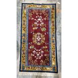 Chinese superwash burgundy ground rug, central floral medallion on stylised floral field, multiple