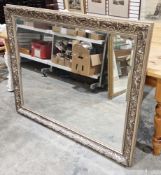 Large Art Nouveau-style carved rectangular wall mirror with silvered lotus flower decorated frame