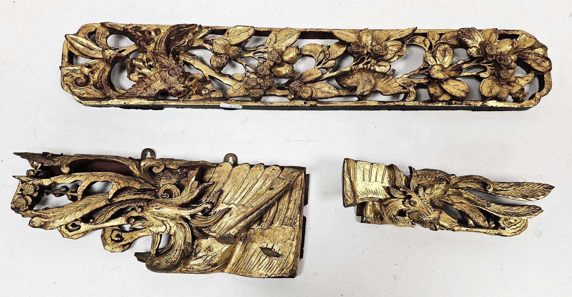 Group of Chinese Qing Dynasty red lacquered and gilt carved panels and fragments including a panel