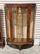 20th century mahogany glazed display cabinet of demi lune form, the single door opening to reveal