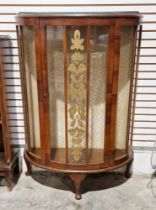 20th century mahogany glazed display cabinet of demi lune form, the single door opening to reveal