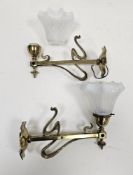 Pair of Art Nouveau brass wall lights with whiplash design decoration, the sconces inscribed '