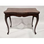 George III mahogany foldover card table of French Hepplewhite style, the shaped top with carved