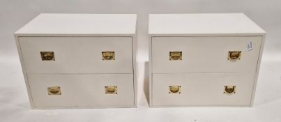 Pair of modern white painted chests of two long drawers with brass flush handles, each with a